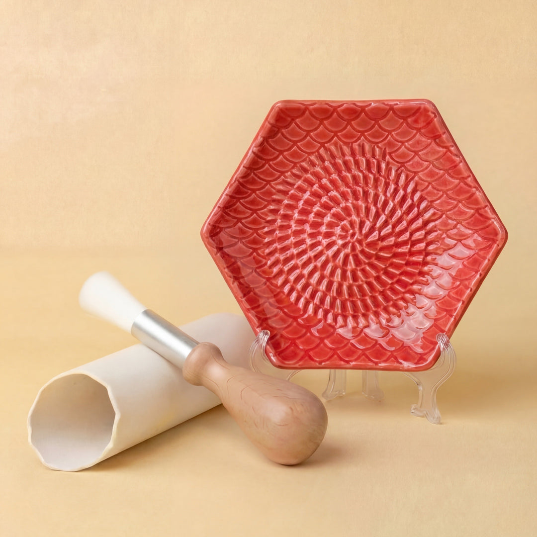 red ceramic grating plate with garlic peeler and brush